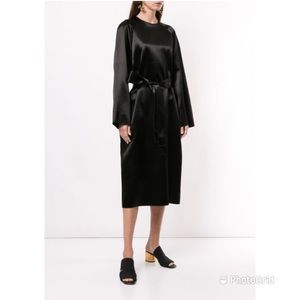 The Row JIA dress crafted from satin features long sleeves and matching belt